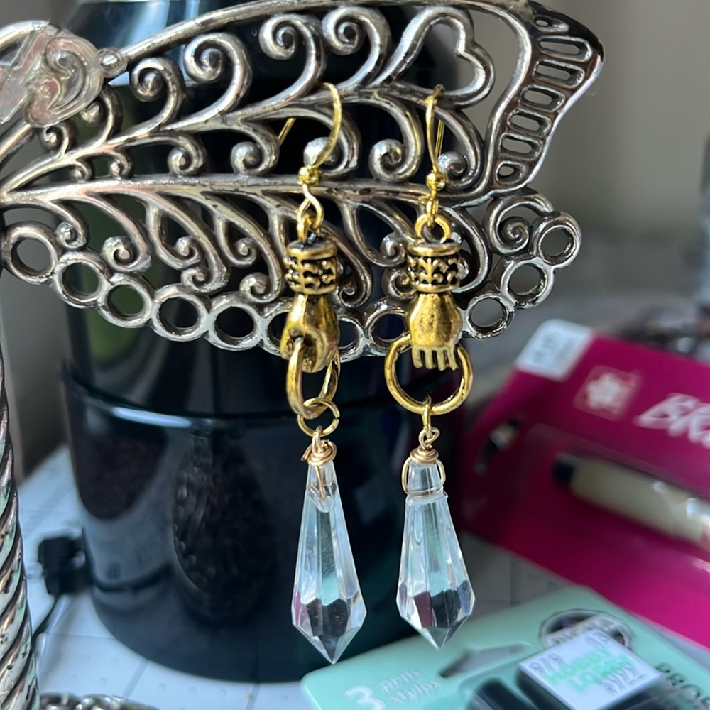 Hands holding crystal earrings artist made goldtone Victorian hand